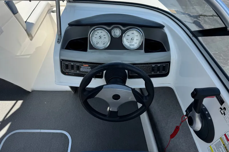 Slide: The Image of 2012 Bayliner 195 Bowrider dashboard with steering wheel and control panel. - 24