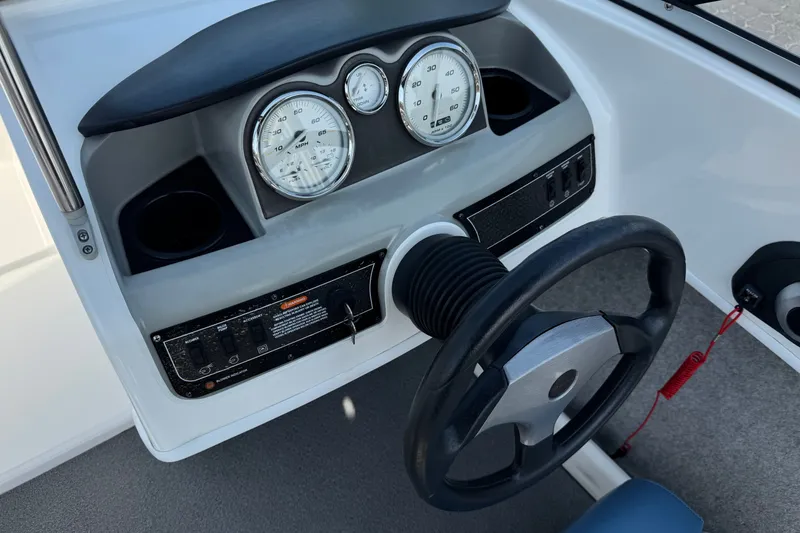 Slide: The Image of Dashboard of a 2012 Bayliner 195 Bowrider boat with steering wheel and gauges. - 25