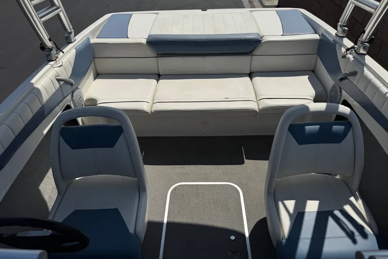 Slide: The Image of 2012 Bayliner 195 Bowrider interior with white seating and dual captain chairs. - 16