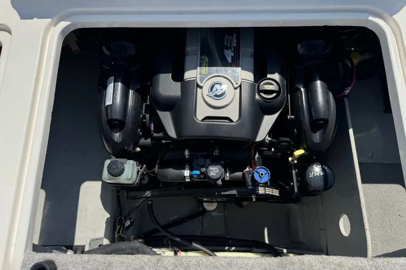 Slide: The Image of 2012 Bayliner 195 Bowrider engine compartment showcasing a clean, well-maintained motor. - 19