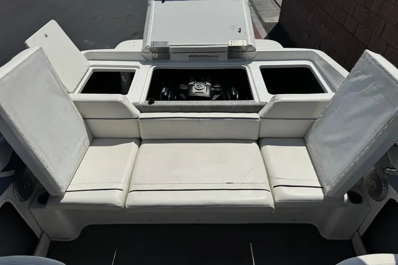 Slide: The Image of 2012 Bayliner 195 Bowrider boat interior with open engine compartment and white seating. - 17