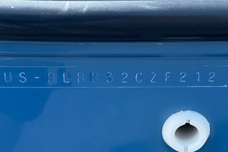 Slide: The Image of Hull identification number on a 2012 Bayliner 195 Bowrider boat, blue surface. - 29
