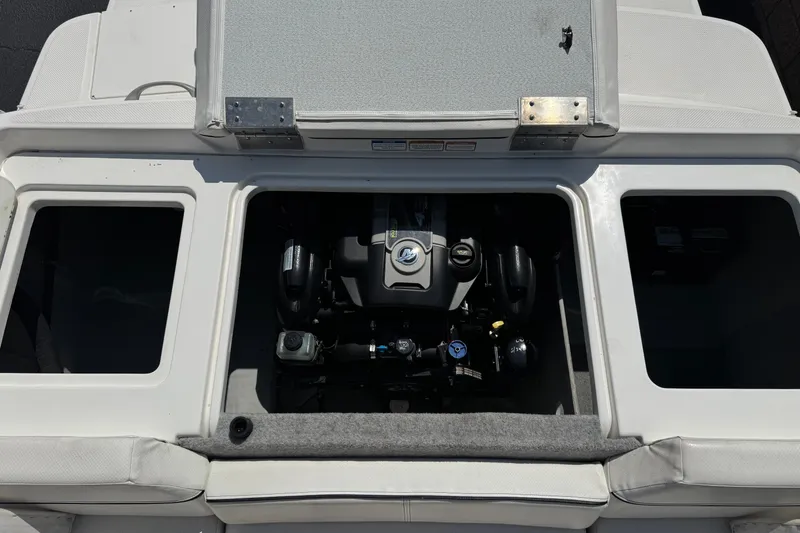 Slide: The Image of Engine compartment of a 2012 Bayliner 195 Bowrider boat, showcasing internal components. - 18