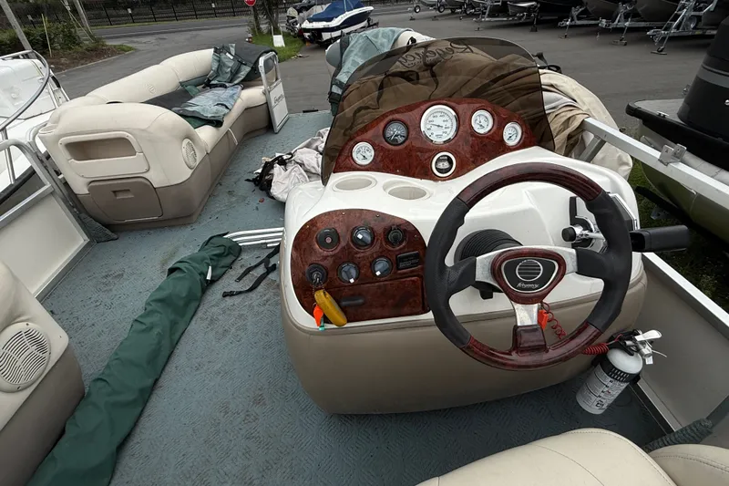 Slide: The Image of 2004 Sun Tracker Party Barge 22 Regency Edition interior with steering wheel and dashboard controls. - 13