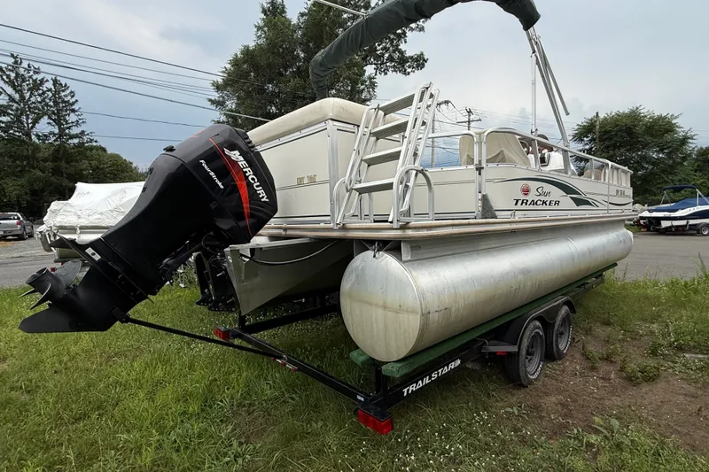 The Image of 2004 Sun Tracker Party Barge 22 Regency Edition on trailer, featuring Mercury outboard motor. - 0