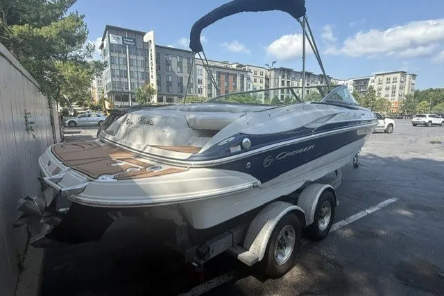 Slide: The Image of 2008 Crownline 200 LS boat on trailer in urban parking lot. - 2