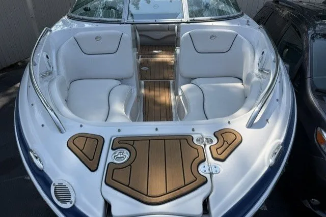 Slide: The Image of 2008 Crownline 200 LS boat with white seating and wood accents, docked outdoors. - 4