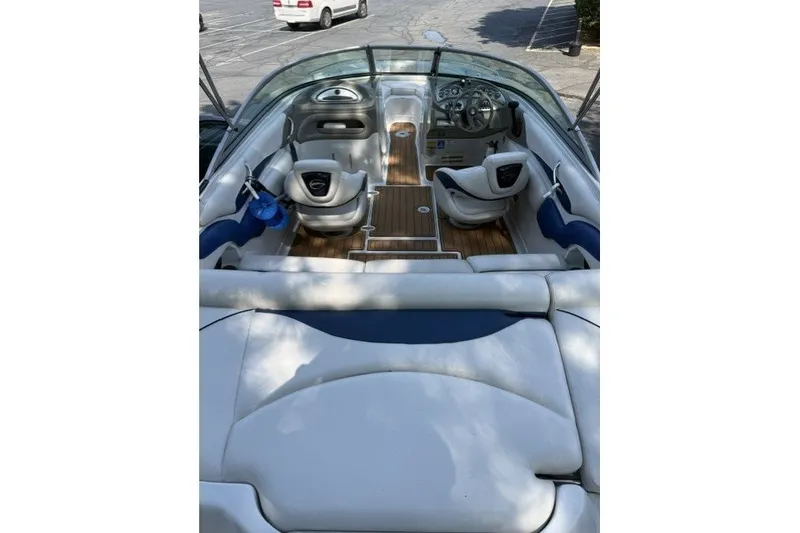 Slide: The Image of 2008 Crownline 200 LS boat interior with white seating and wood flooring. - 5