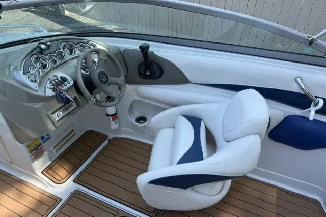 Slide: The Image of 2008 Crownline 200 LS boat interior with steering wheel and white seating. - 9