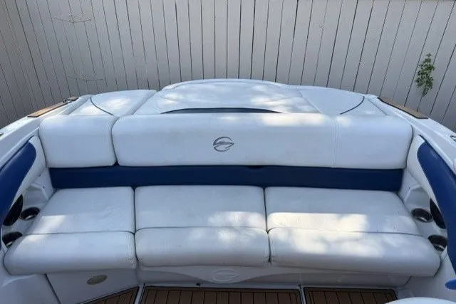 Slide: The Image of 2008 Crownline 200 LS boat with white and blue seating, wooden deck, and sleek design. - 7