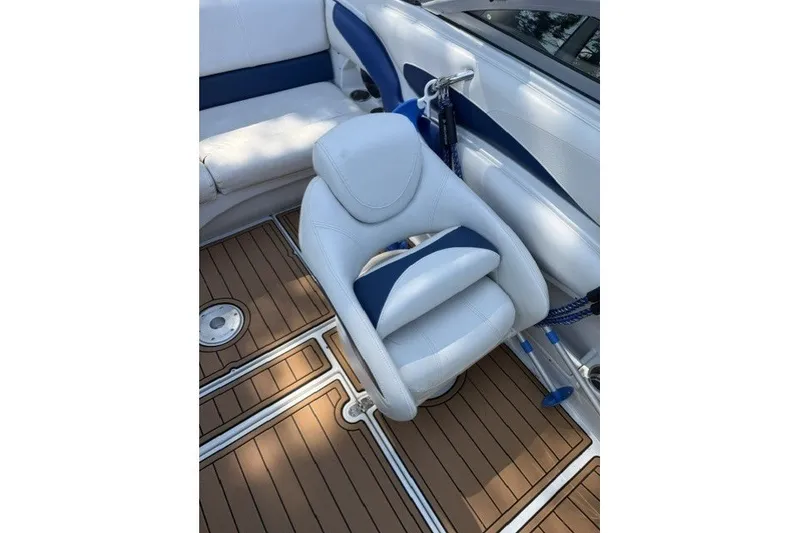 Slide: The Image of 2008 Crownline 200 LS boat interior with white and blue seating, teak-style flooring. - 13