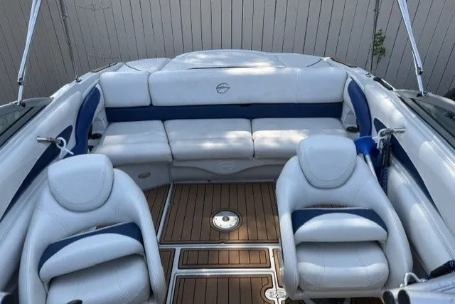 Slide: The Image of 2008 Crownline 200 LS boat interior with white and blue seating, wooden flooring. - 8