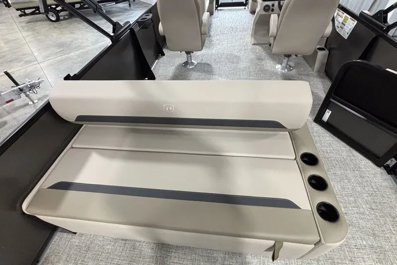 Slide: The Image of 2027 Premier 220 Sunscape RL - CL boat interior with beige seating and cup holders. - 23
