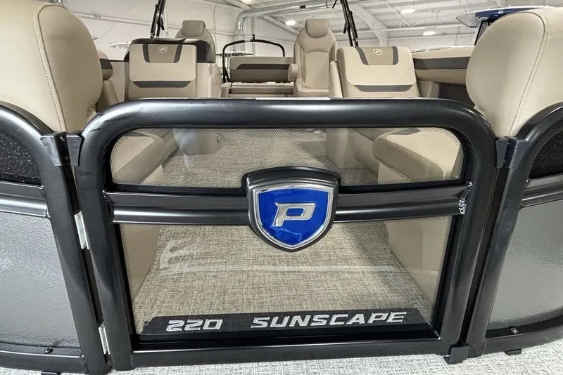 Slide: The Image of Premier 220 Sunscape RL - CL 2027 boat interior with beige seating and logo. - 4