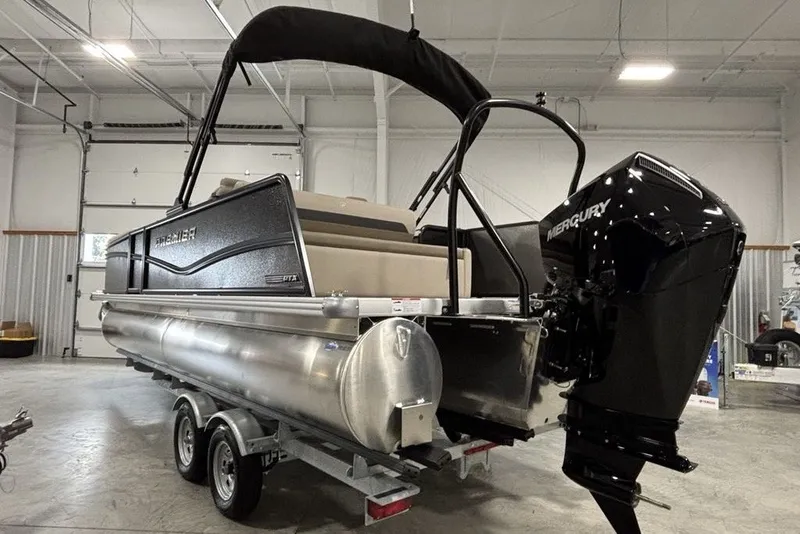Slide: The Image of 2027 Premier 220 Sunscape RL - CL pontoon boat with Mercury engine in a garage. - 3
