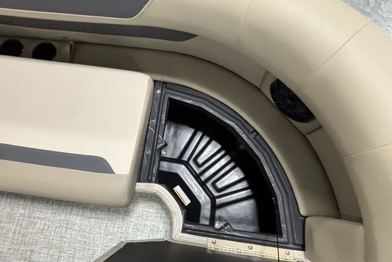 Slide: The Image of 2027 Premier 220 Sunscape RL - CL boat interior storage compartment with beige seating. - 10