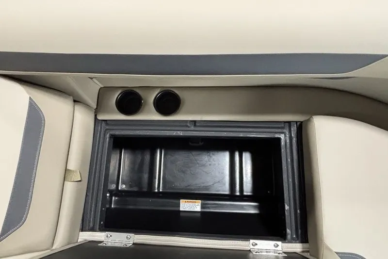 Slide: The Image of 2027 Premier 220 Sunscape RL - CL boat storage compartment with beige and gray interior. - 8