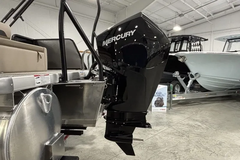 Slide: The Image of Premier 220 Sunscape RL - CL 2027 boat with Mercury outboard motor in showroom. - 2