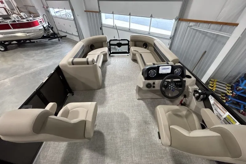 Slide: The Image of 2027 Premier 220 Sunscape RL - CL pontoon boat interior with beige seating and steering console. - 16