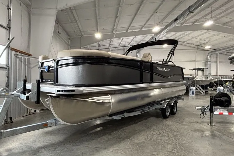 Slide: The Image of 2027 Premier 220 Sunscape RL - CL pontoon boat in a showroom on a trailer. - 6