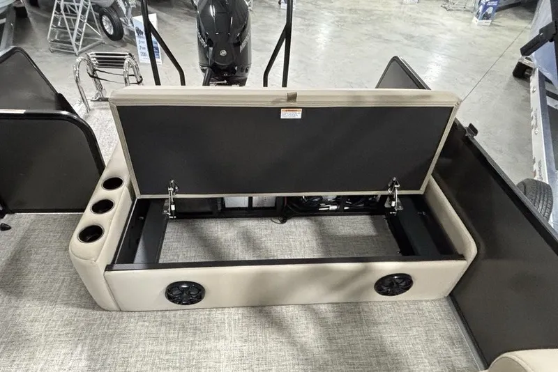 Slide: The Image of Open storage compartment in 2027 Premier 220 Sunscape RL - CL boat, featuring cup holders and speakers. - 22