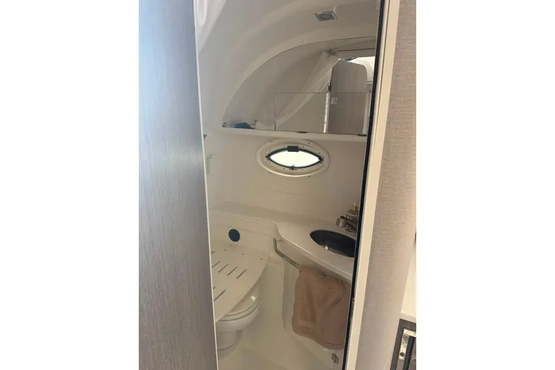 Slide: The Image of Interior of 2021 Monterey 355 Sport Yacht bathroom with porthole and sink. - 26