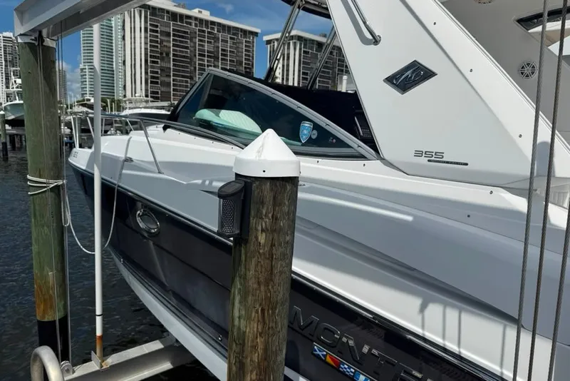 Slide: The Image of 2021 Monterey 355 Sport Yacht docked at marina with cityscape background. - 19