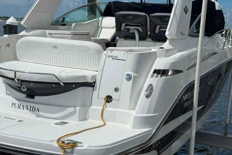 Slide: The Image of 2021 Monterey 355 Sport Yacht docked, featuring sleek design and luxurious seating. - 16