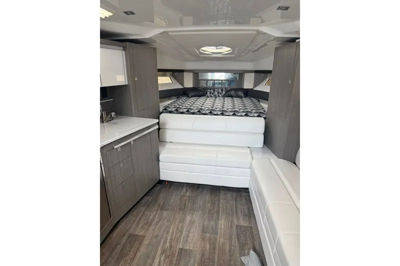 Slide: The Image of Interior of 2021 Monterey 355 Sport Yacht with modern furnishings and wood flooring. - 29