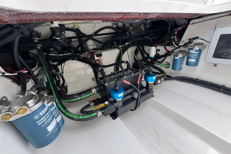 Slide: The Image of Engine compartment of 2027 Caymas 401 DR boat with Yamaha marine fuel filters and wiring. - 58