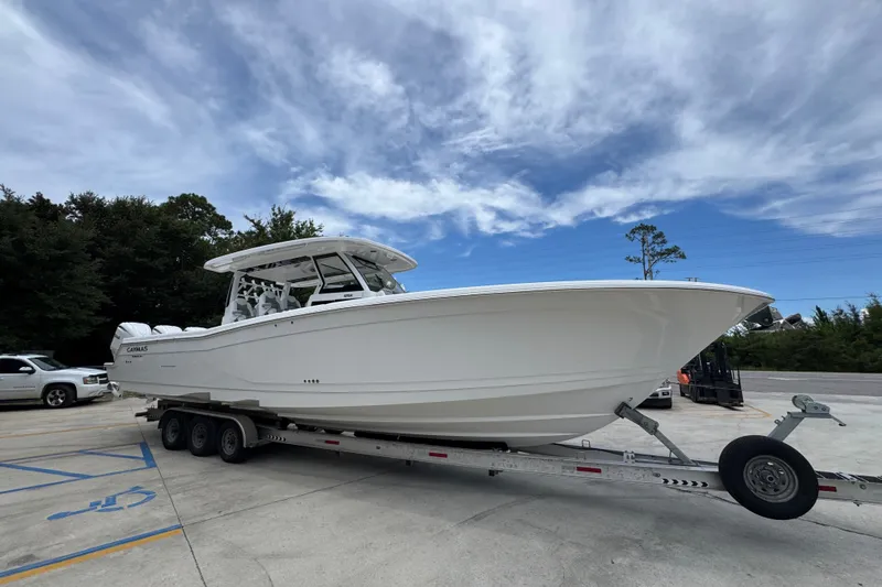 Slide: The Image of 2027 Caymas 401 DR boat on trailer under blue sky. - 10