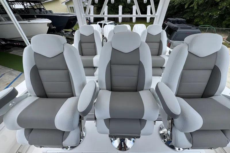 Slide: The Image of Luxurious seating on 2027 Caymas 401 DR boat, featuring plush gray and white upholstery. - 37