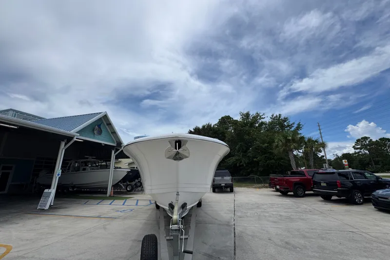 Slide: The Image of 2027 Caymas 401 DR boat on trailer at dealership under cloudy sky. - 7