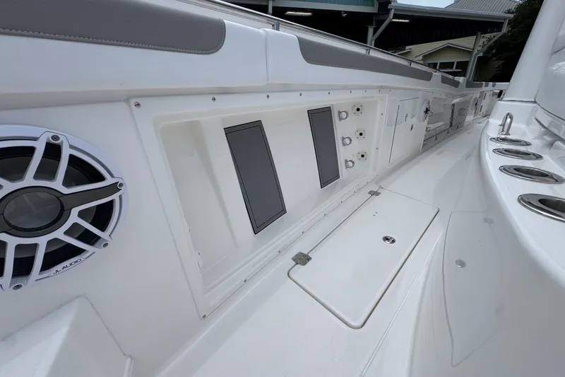 Slide: The Image of 2027 Caymas 401 DR boat interior with audio system and storage compartments. - 26