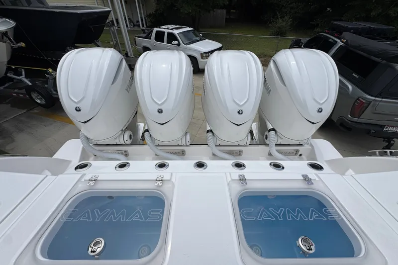 Slide: The Image of Four powerful outboard engines on a 2027 Caymas 401 DR boat, showcasing sleek design. - 54