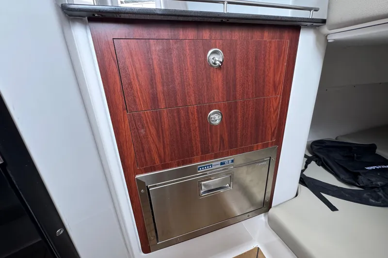 Slide: The Image of Interior of 2027 Caymas 401 DR boat with wood paneling and stainless steel drawer. - 34