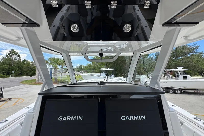 Slide: The Image of 2027 Caymas 401 DR boat cockpit with Garmin navigation displays and modern design. - 42
