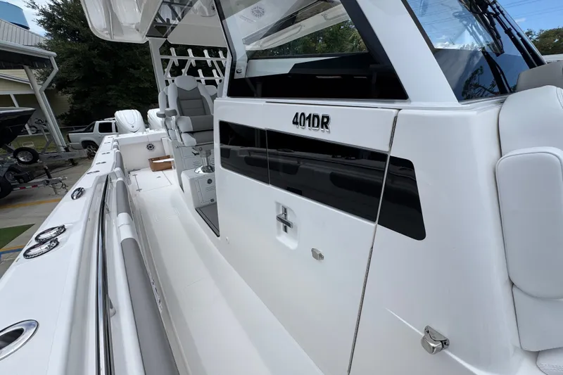 Slide: The Image of 2027 Caymas 401 DR boat, sleek white exterior with modern design elements. - 29