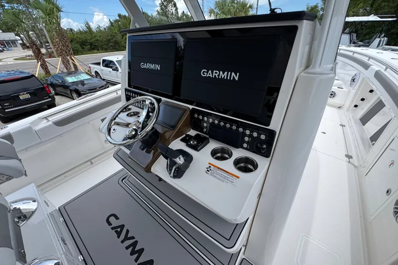 Slide: The Image of 2027 Caymas 401 DR boat dashboard with dual Garmin displays and steering wheel. - 44