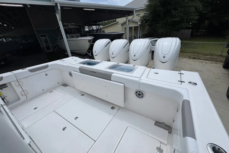 Slide: The Image of 2027 Caymas 401 DR boat with four powerful outboard engines, spacious deck, and modern design. - 52