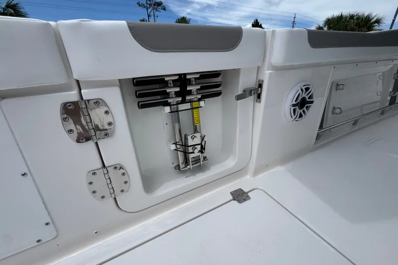Slide: The Image of 2027 Caymas 401 DR boat interior, featuring storage compartment and speaker on deck. - 50