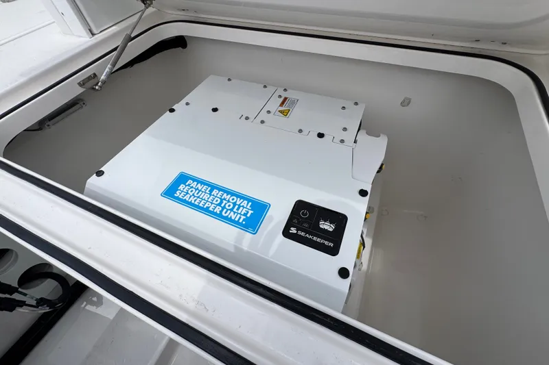 Slide: The Image of Seakeeper unit in 2027 Caymas 401 DR boat compartment, requiring panel removal for access. - 57