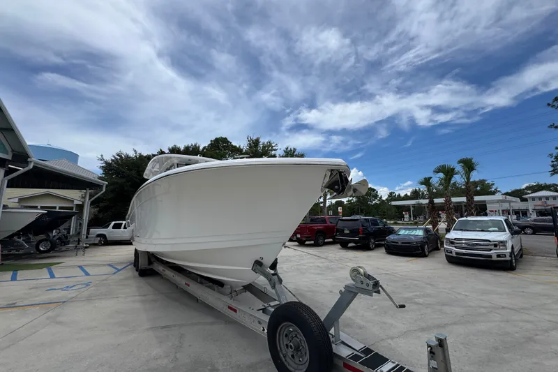 Slide: The Image of 2027 Caymas 401 DR boat on trailer in parking lot under cloudy sky. - 8