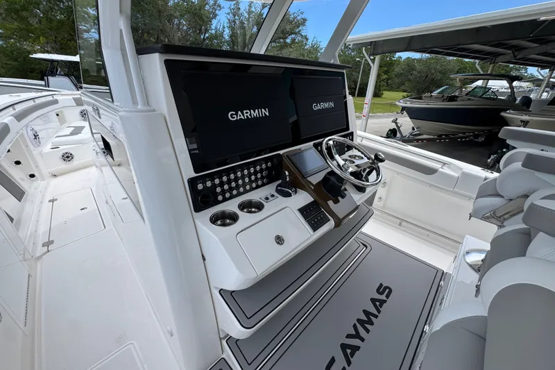 Slide: The Image of 2027 Caymas 401 DR boat cockpit with Garmin displays and modern steering console. - 40