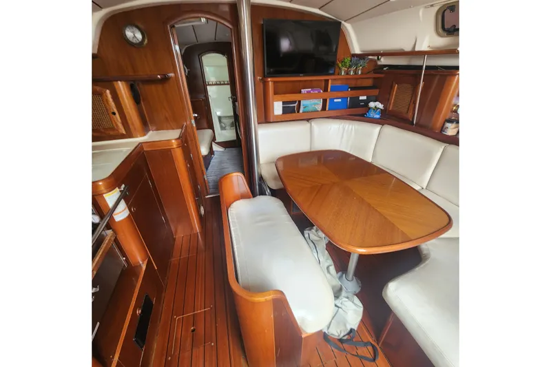Slide: The Image of Interior of 1999 Beneteau Oceanis 411 Celebration yacht with wooden furnishings and cozy seating. - 18