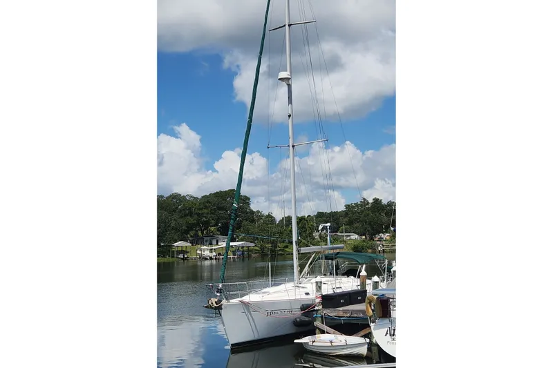 The Image of Sailboat Beneteau Oceanis 411 Celebration 1999 docked on a serene river. - 0