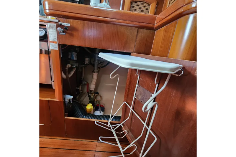 Slide: The Image of Interior view of a 1999 Beneteau Oceanis 411 Celebration yacht's wooden cabinetry and storage area. - 30