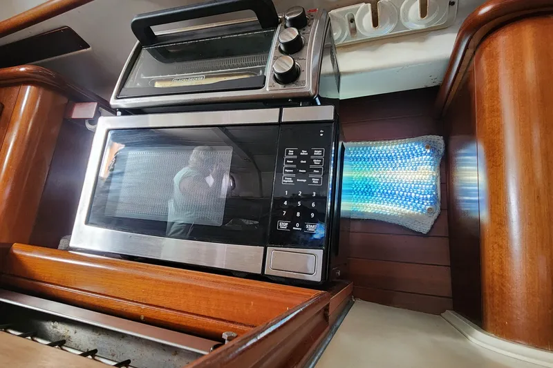 Slide: The Image of Microwave and toaster in the galley of a 1999 Beneteau Oceanis 411 Celebration yacht. - 33
