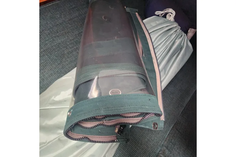 Slide: The Image of Rolled-up sail cover on Beneteau Oceanis 411 Celebration, 1999 model, with zipper and snap details. - 36