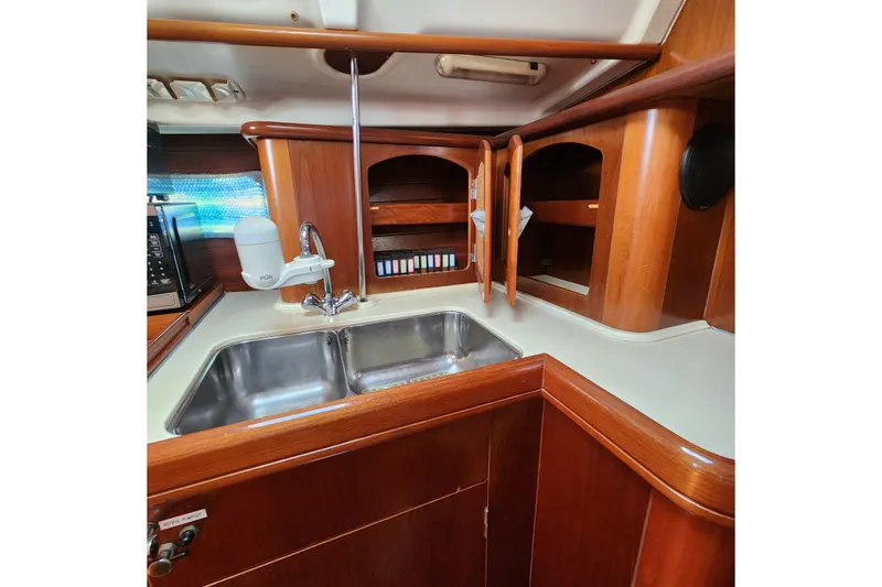 Slide: The Image of Interior of 1999 Beneteau Oceanis 411 Celebration yacht kitchen with wooden cabinets and sink. - 25